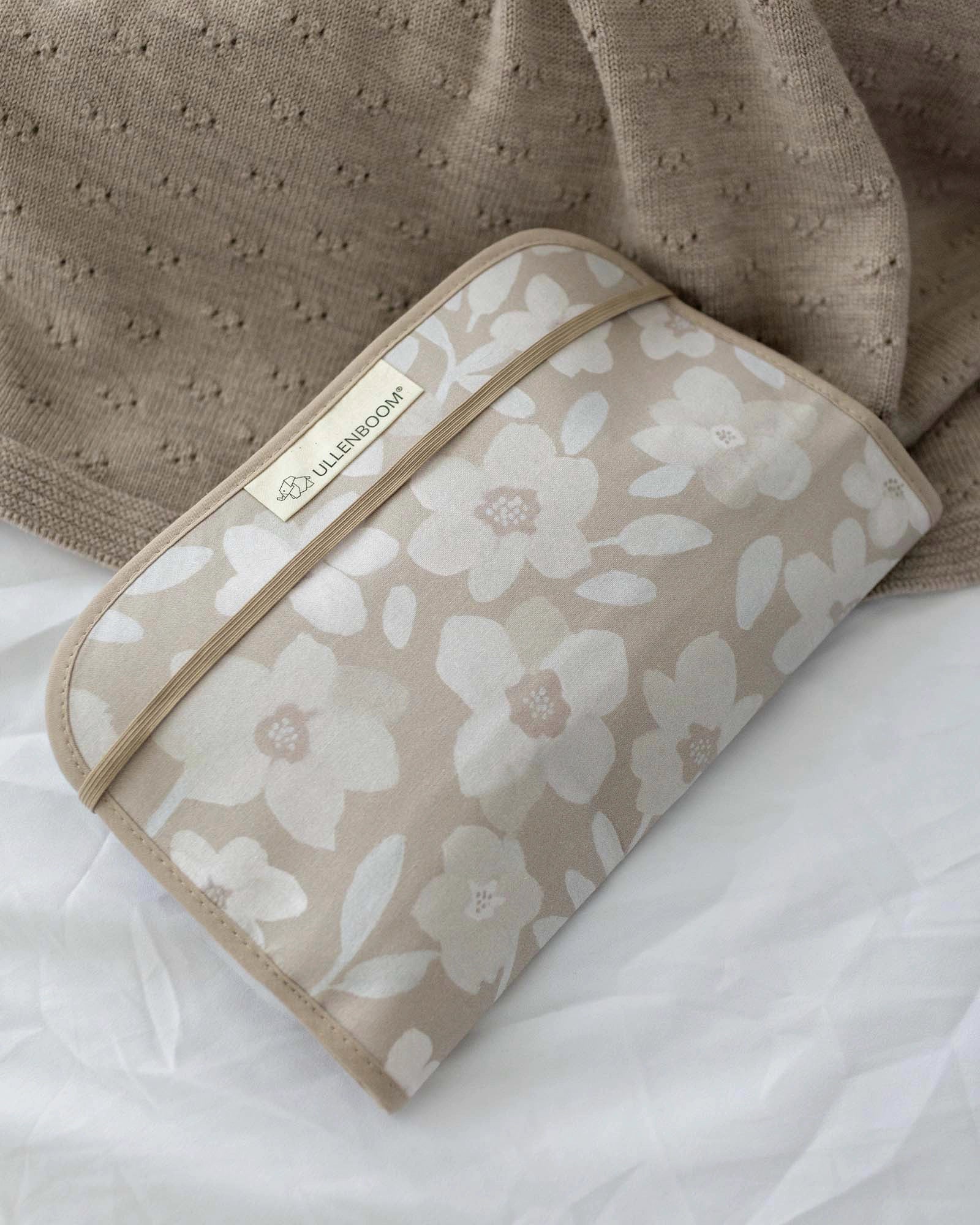 Beige cotton diaper clutch with white and light brown floral print, elastic band closure, and ULLENBOOM label.