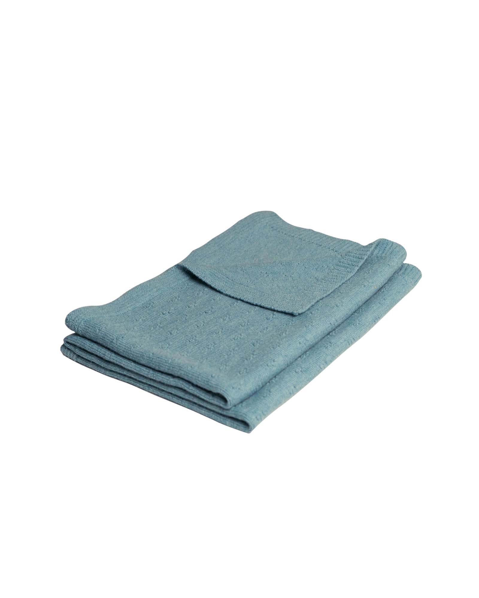 Folded turquoise merino wool baby blanket with a subtle knit texture.