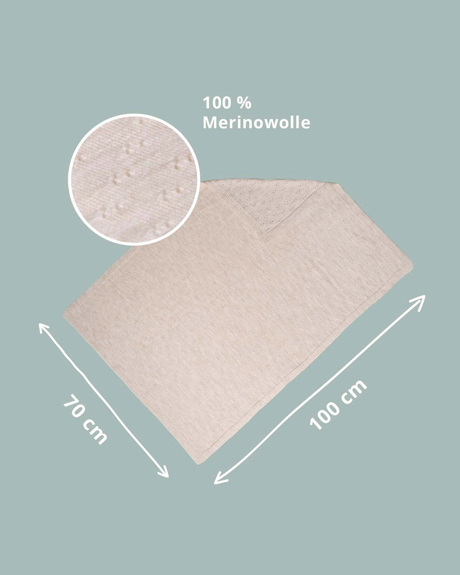 Cream 100% Merino wool baby blanket, 70x100 cm, with a subtle textured knit.