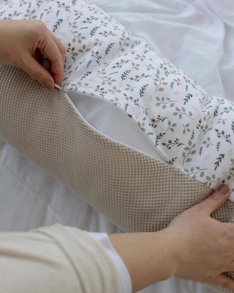Beige waffle-knit and white floral cotton nursing pillow cover with hidden zipper.