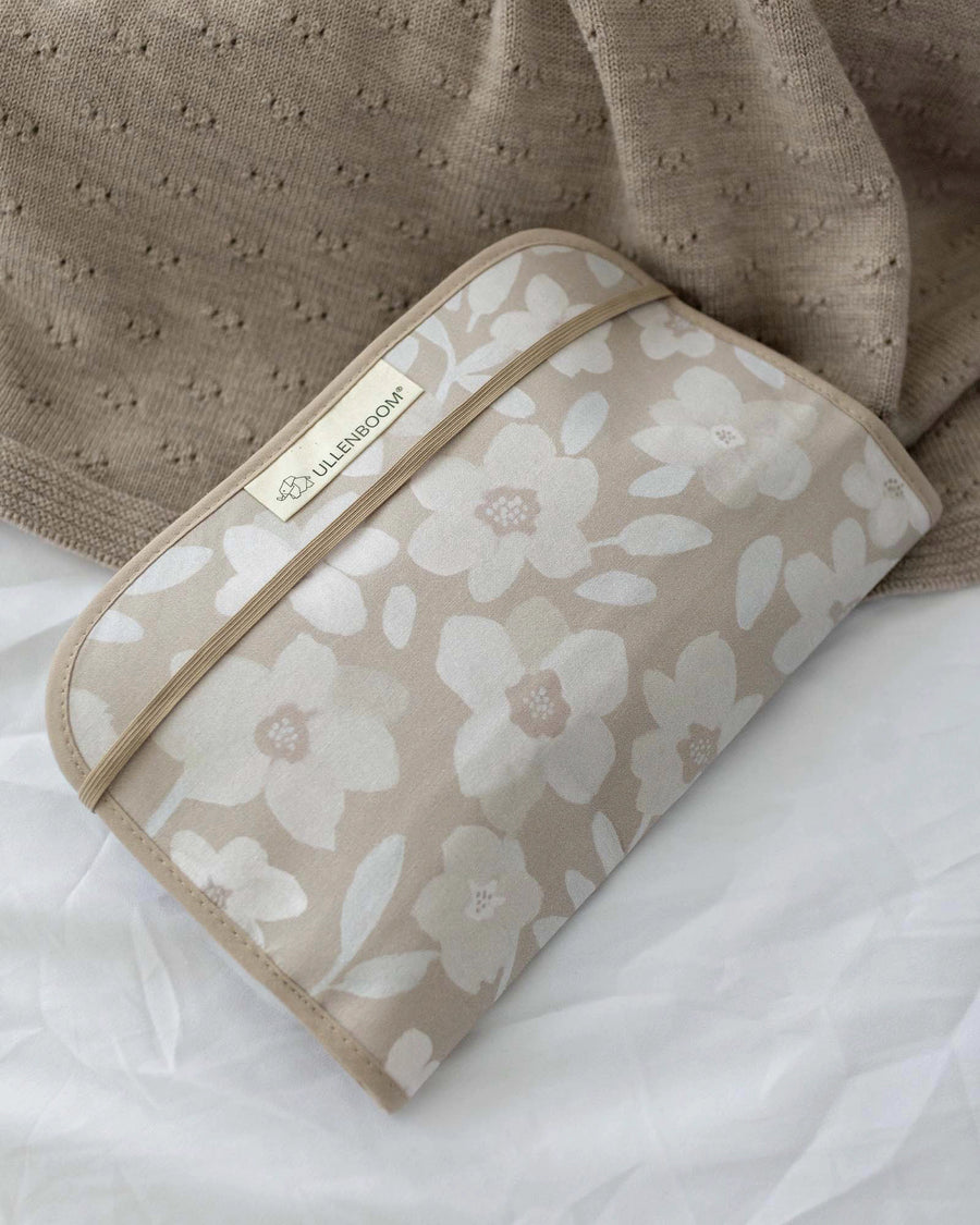 Beige cotton diaper clutch with white and light brown floral print, elastic band closure, and ULLENBOOM label.