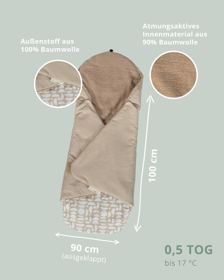 Sand-colored baby wrap blanket with a dotted cotton exterior and soft fleece lining, measuring 100x90cm.
