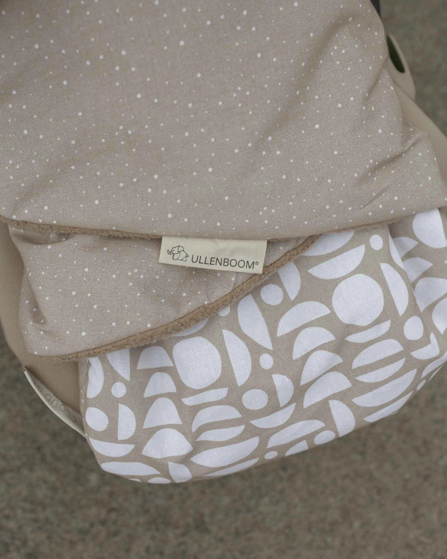 Ullenboom Classic Sand baby wrap blanket with white polka dots and geometric pattern lining.