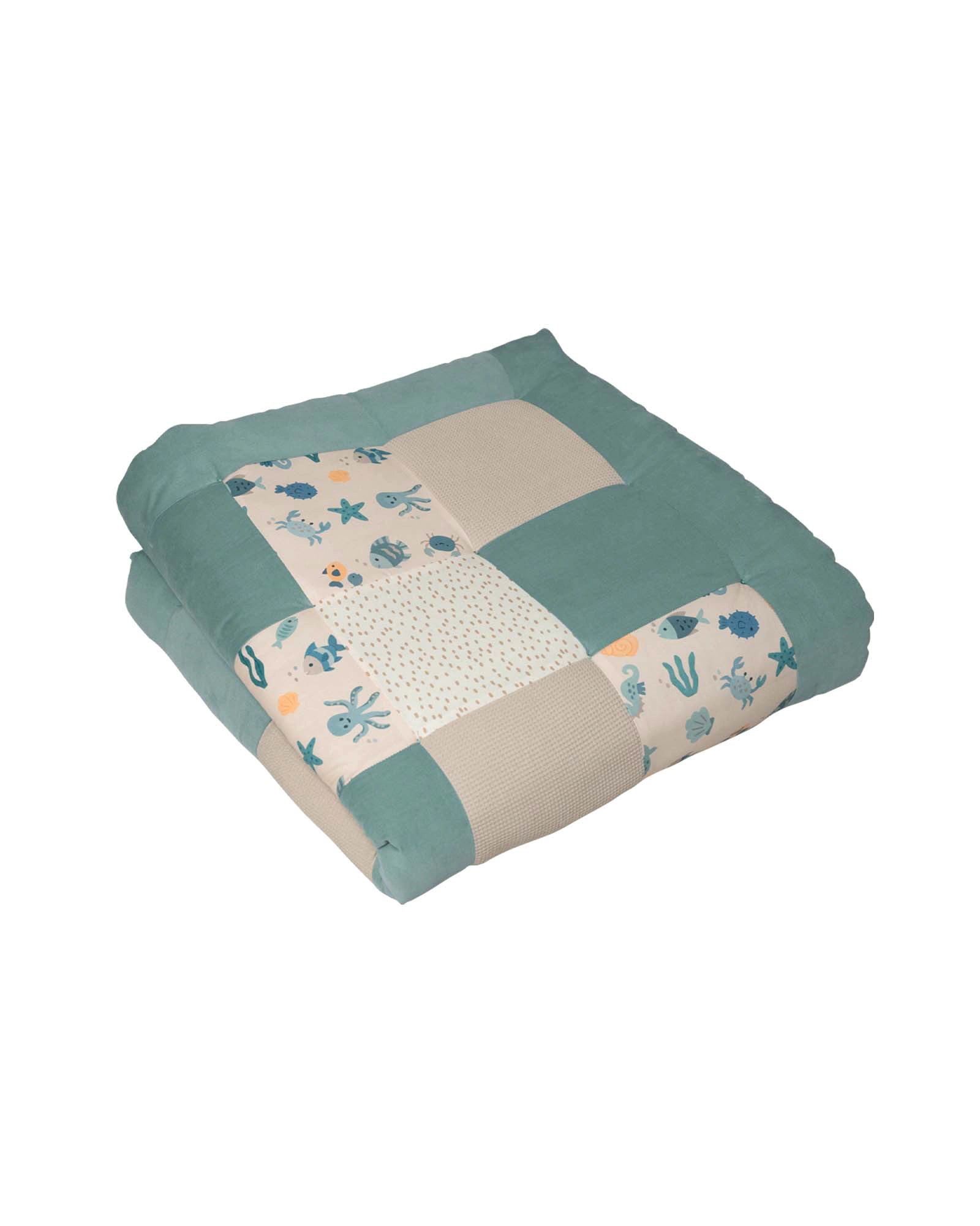 Soft, thick patchwork baby play mat with underwater sea creature design in teal, beige, and white.