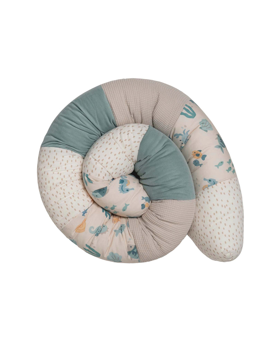 Soft, thick baby bed bumper in an underwater world design with blue, beige, and patterned cotton fabric.